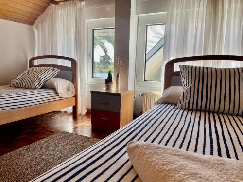 a bedroom with two beds and a window at Escuela de Surf Waves Sound in Santoña