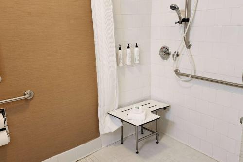 a bathroom with a shower and a sink in it at AmericInn by Wyndham St Cloud MN Shopping Area in Saint Cloud