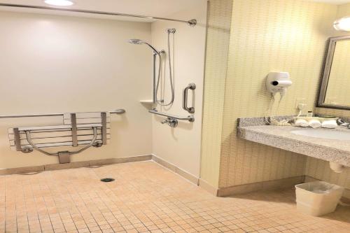 a bathroom with a shower and a sink at Wingate by Wyndham Kittanning in Kittanning