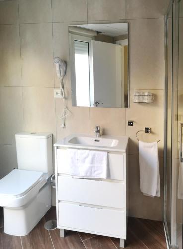 a bathroom with a toilet and a sink and a mirror at El Indio Chocolatería Boutique in Pinto