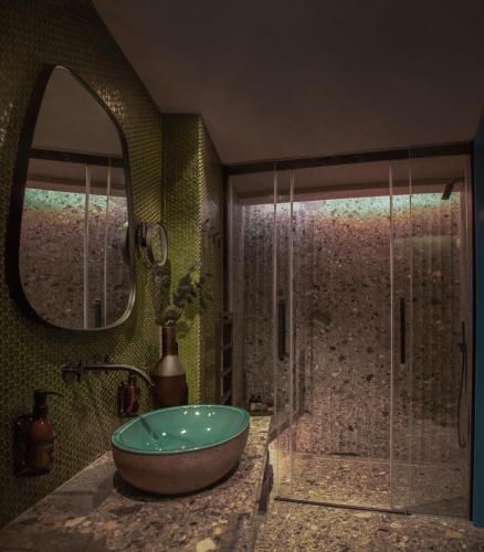 a bathroom with a tub and a shower with a mirror at Unique Boutique Hotel Antibes Juan-les-Pins in Antibes
