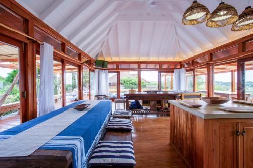 a large room with a bed and a table at Aloha 15 in Ponta Mamoli