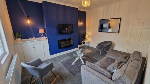 a living room with a couch and a fireplace at Cosy home perfect for families and contractors in Darlington