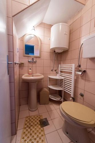 a small bathroom with a sink and a toilet at Apartmani Pavlov in Arandjelovac