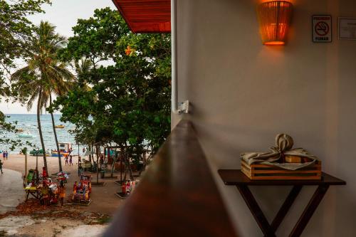 a view of a beach from a room with a window at AL MAR SUÍTES in Praia do Forte