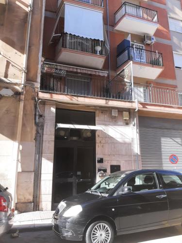 a black car parked in front of a building at CASA STALLONE in Bari