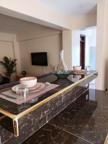 a living room with a table with bowls on it at Rawin Homes in Nyeri