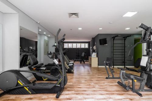 a gym with several treadmills and exercise bikes at Suítes Inside Hotel Windham Paulista in São Paulo