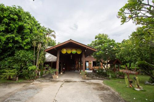 a building with a bunch of yellow disks on it at OYO 909 Guiding Star Resort in Hang Dong