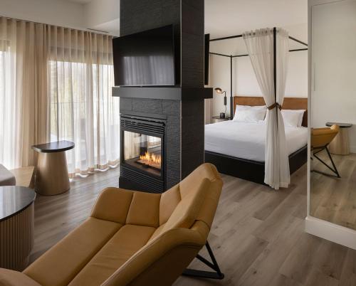a hotel room with a fireplace and a bed at Estérel Resort in Esterel