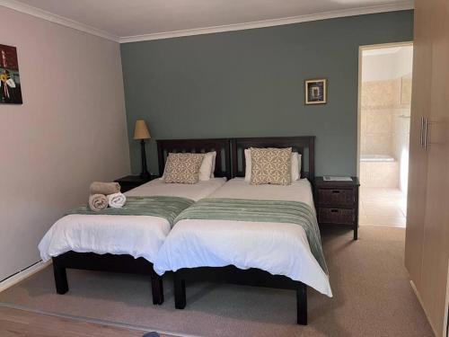 a bedroom with a large bed in a room at Lovely Garden Studio 5 - 10 min walk to the beach in Cape Town