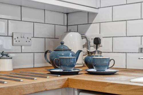 a kitchen counter with tea pots and cups on it at 1 The Barn - Brassington in Brassington