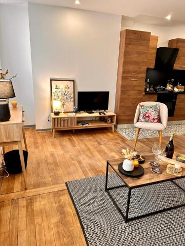 a living room with a couch and a table at Appartement Couteliers-Centre ville-4pers in Moulins