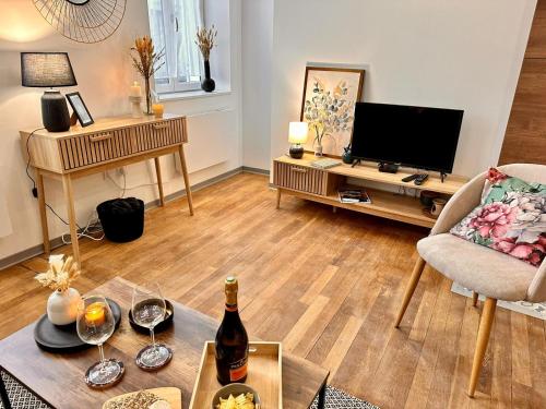a living room with a bottle of wine on a table at Appartement Couteliers-Centre ville-4pers in Moulins
