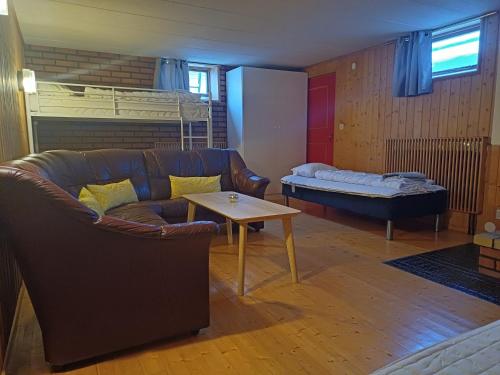 a living room with a couch and a bed at Kiruna accommodation Läraregatan 19 b in Kiruna