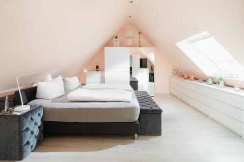 a bedroom with a bed in a attic at Aurora in Norderney