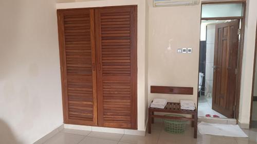 uma porta de madeira numa casa de banho com uma mesa em Suhufi Palace Hotel em Mombaça