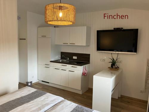 een kamer met een keuken, een tv en een bed bij Iflands Hof in Brehme