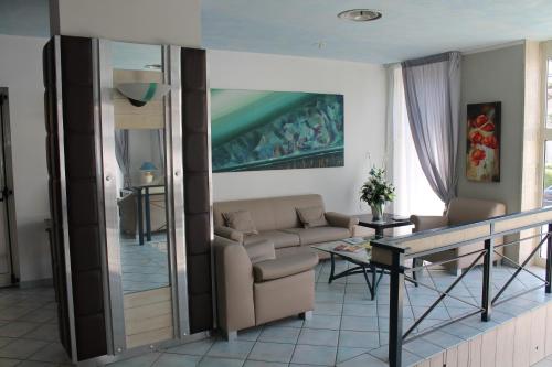 a living room with a couch and a table at Hotel Mediterraneo in Roccella Ionica
