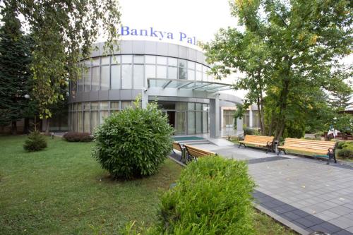 a building with two benches in front of it at Hotel Bankya Palace in Bankya