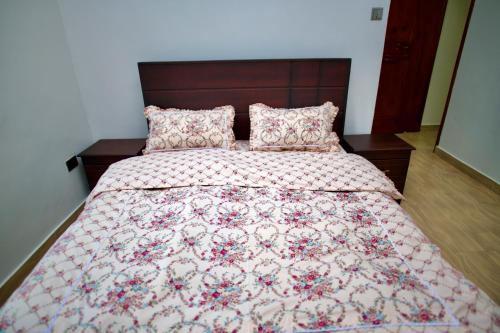 a bedroom with a bed with a quilt and pillows at ATA Lux Apartments in Kira