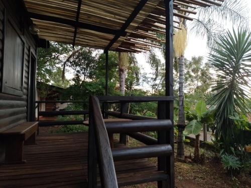 a wooden porch of a house with a pergola at Cabañas Misioneras in San Ignacio