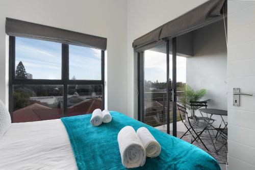 a bedroom with a bed with towels on it at Atlantic Port 9 by Host Agents in Bloubergstrand