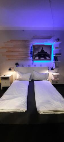 a bedroom with two beds and a tv on the wall at Civico 4 in Castrovillari