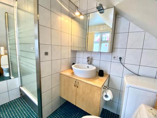 a bathroom with a sink and a mirror at Day Dream - Vesturgata 5a Luxury Apartment in Reykjavík