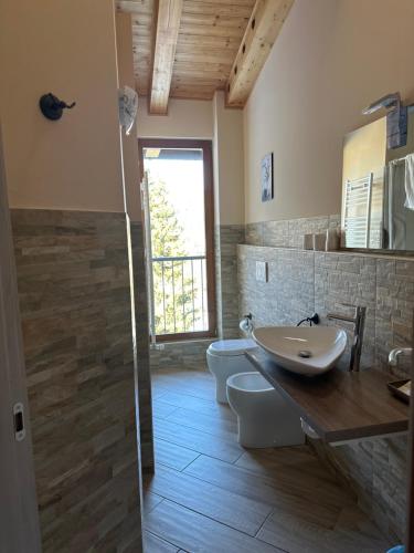 a bathroom with two toilets and a sink at Hotel Chalet Casa Cesana in Cesana Torinese
