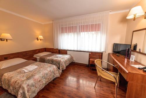 Posteľ alebo postele v izbe v ubytovaní Hotel Skaut