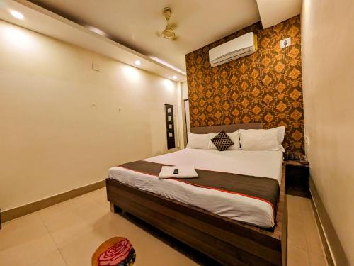 a bedroom with a large bed in a room at HOTEL SUN CITY in Puri