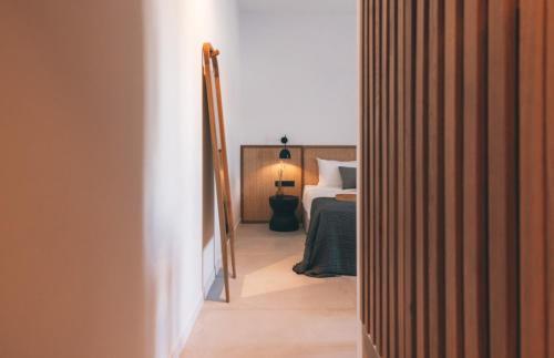 a hallway leading to a bedroom with a bed at Adama Mykonos Boutique Hotel in Mýkonos City