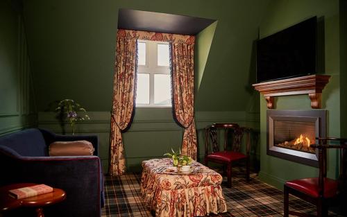 a living room with a fireplace and a window at Slieve Donard in Newcastle