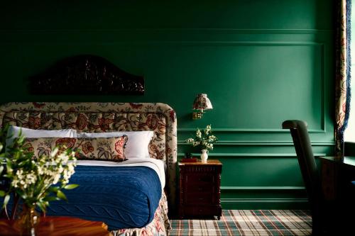 a green bedroom with a bed and a green wall at Slieve Donard in Newcastle
