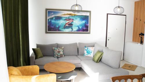 a living room with a couch and a table at Palm Side Drymades in Dhërmi