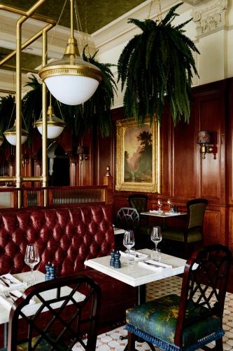 a restaurant with a red couch and tables and chairs at Slieve Donard in Newcastle