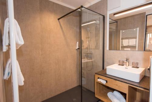 a bathroom with a sink and a shower at Hotel Muhr in Pöllauberg