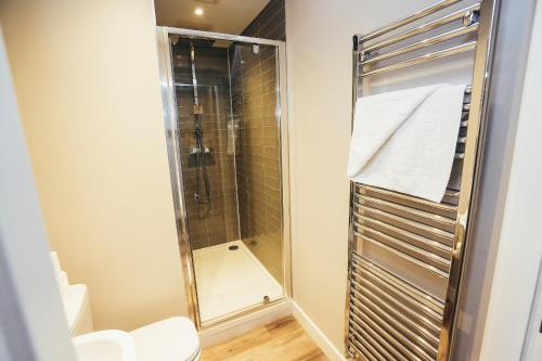 a bathroom with a shower and a toilet at The Stay Company, Devonshire Court in Nottingham