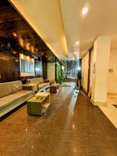 a large living room with couches and a table at HOTEL SUN CITY in Puri