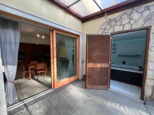 a balcony with sliding glass doors and a table with a tub at Villa Roma Open Space - Private heated pool & Mini SPA - in Rome
