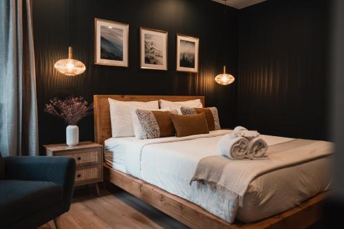 a bedroom with a bed with black walls and lights at Starry Tremblant l Design Glass View Cabin Spa Lake in Saint-Rémi-dʼAmherst