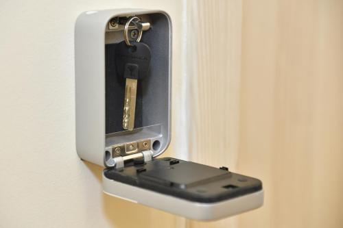 a device is attached to a door with a key at Palmy Apartmanhouse Maglód in Maglód