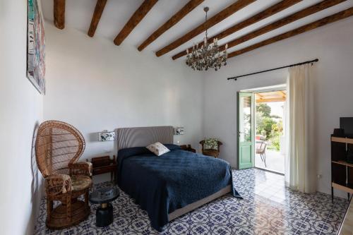 a bedroom with a bed with a blue bedspread at Frangimare - La Malandrina in Malfa