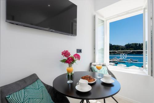 a dining room with a table and a window at La Porta 2, seaview apartment in the center in Cavtat