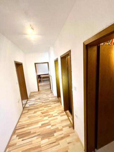a corridor of an apartment with wooden floors and doors at Monteurwohung Leoben, Uni, LCS in Judendorf