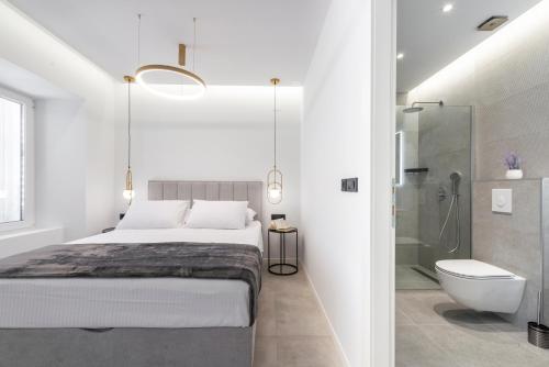 a bedroom with a bed and a shower and a toilet at La Porta 2, seaview apartment in the center in Cavtat