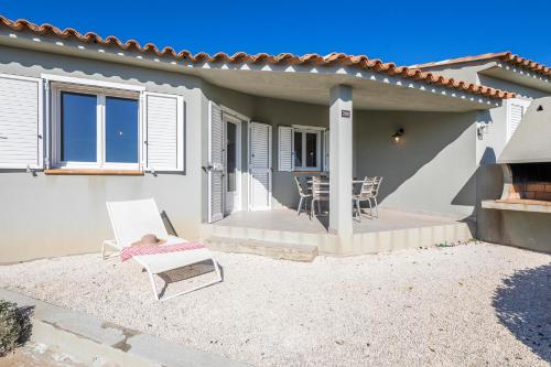 a house with a patio with a table and chairs at Résidence Santa Monica in Bonifacio