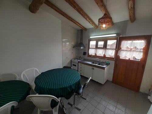 a kitchen with a table and chairs and a sink at Abi in Esquel