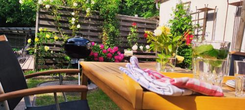 a table with a yellow table cloth on it with flowers at Waldidylle in Küsten
